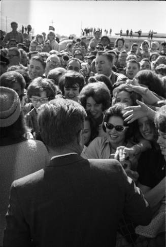 Image of President Kennedy greeting the crowd at Love Field