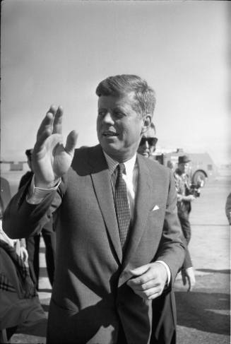 Image of President Kennedy waving to the crowd at Love Field