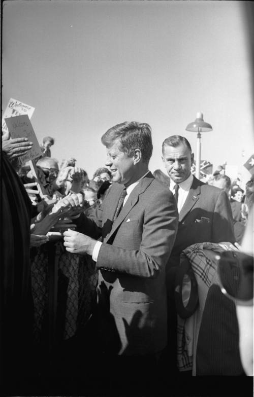 Image of President Kennedy greeting the crowd at Love Field