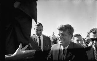 Image of President Kennedy greeting the crowd at Love Field