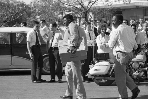Image of unidentified men carrying boxes outside of Parkland Hospital