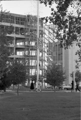 Image of the American flag at half staff outside Parkland Hospital