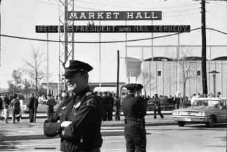 Image of Dallas police officers standing guard outside the Dallas Trade Mart