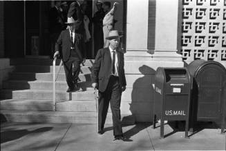 Image of Dallas Police officers exiting the Texas School Book Depository