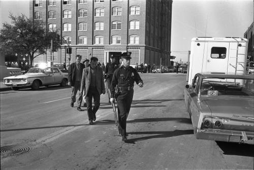 Image of the "three tramps" being escorted to the Sheriff's office