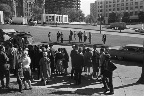 Image of a crowd gathered along Elm Street minutes after the assassination