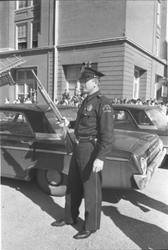 Image of a Dallas Police officer outside the Texas School Book Depository