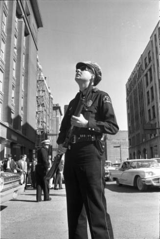 Image of a Dallas Police officer outside of the Texas School Book Depository