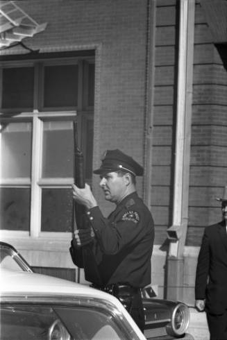 Image of a Dallas Police officer in the intersection of Elm and Houston streets