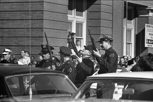 Image of Dallas Police officers in the intersection of Elm and Houston streets