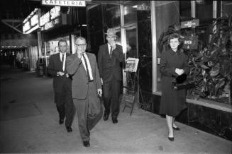 Image of pedestrians in downtown Dallas the evening of November 22, 1963