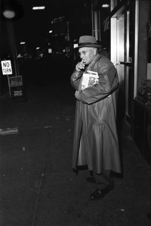 Image of a pedestrian in downtown Dallas the evening of November 22, 1963