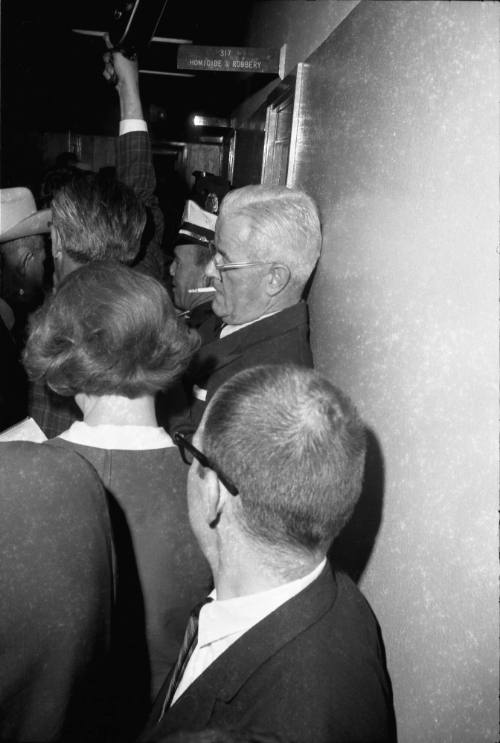 Image of a crowded hallway at Dallas Police Headquarters