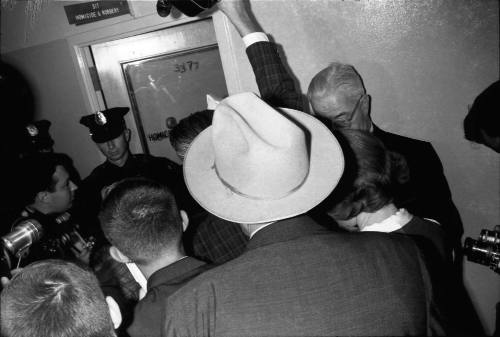 Image of a crowd of reporters outside the Homicide and Robbery Bureau