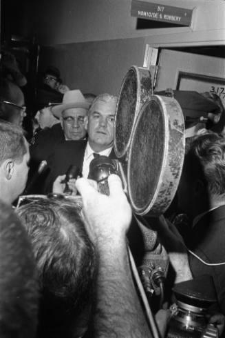 Image of reporters in the hallway at Dallas Police Department headquarters
