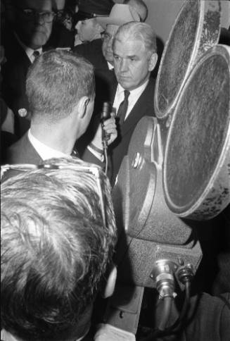 Image of Henry Wade and reporters at the Dallas Police Department headquarters