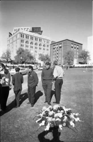 Image of people and flowers in Dealey Plaza the day after the assassination