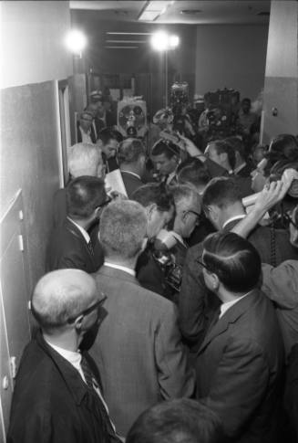 Image of Dallas Police Chief Jesse Curry interviewed in hallway