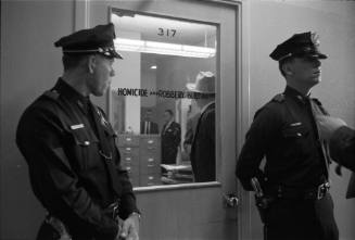 Image of Dallas Police officers guarding the Homicide and Robbery Bureau door