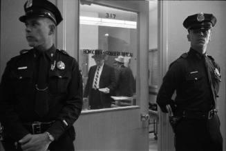 Image of police officers guarding the door of the Homicide and Robbery Bureau