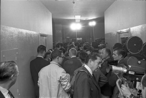 Image of reporters in the hallway at the Dallas Police Department headquarters