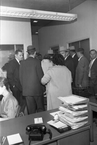 Image of a crowd in the Homicide and Robbery Bureau