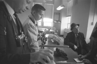 Image of unidentified photographers in the Sheriff's Department press room