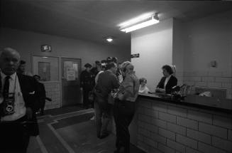 Image of reporters at a nurses station in Parkland Hospital on November 24, 1963
