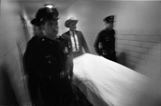 Image of police escorting Oswald's body to the Parkland Hospital morgue