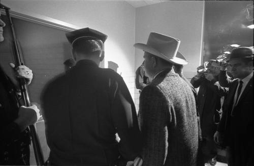 Image of police and detectives escorting Oswald's body into the morgue