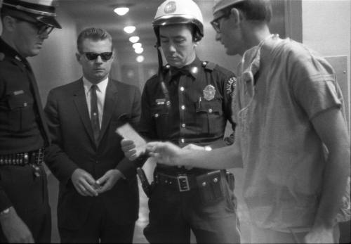 Image of a doctor at Parkland Hospital speaking to Dallas Police officers