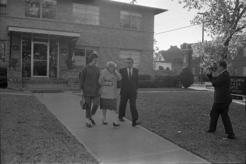 Image of Jack Ruby's sister Eva Grant leaving for the Dallas Police Department
