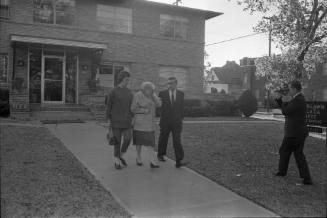 Image of Jack Ruby's sister Eva Grant leaving for the Dallas Police Department