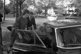 Image of Jack Ruby's sister Eva Grant leaving for the Dallas Police Department