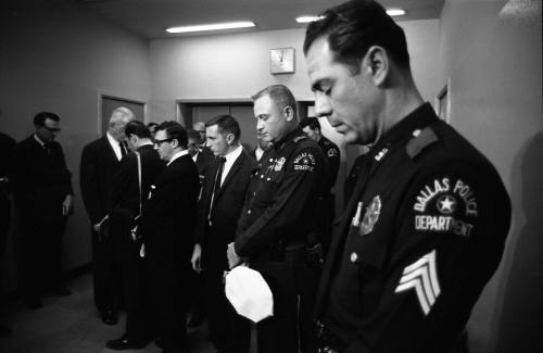 Image of Dallas Police officers observing a moment of silence for Officer Tippit
