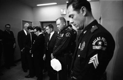 Image of Dallas Police officers observing a moment of silence for Officer Tippit