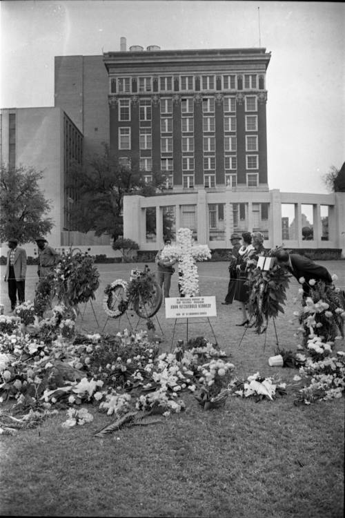 Image of memorial flower arrangements in Dealey Plaza on November 27, 1963