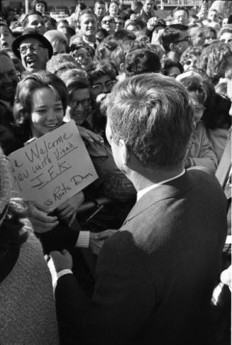 Image of President Kennedy greeting the crowd at Love Field