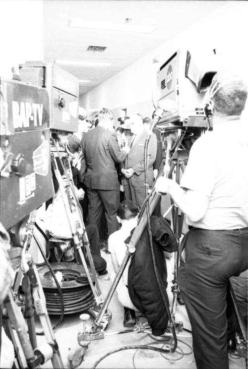 Image of Dallas Police Chief Jesse Curry surrounded by reporters and cameras