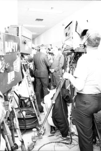 Image of Dallas Police Chief Jesse Curry surrounded by reporters and cameras