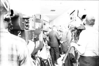 Image of Dallas Police Chief Jesse Curry surrounded by reporters and cameras