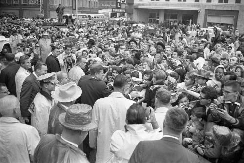 Image of President Kennedy with crowds outside the Hotel Texas