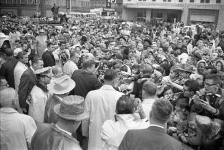 Image of President Kennedy with crowds outside the Hotel Texas