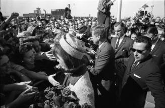 Image of the Kennedys greeting the crowds at Love Field