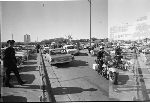 Image of hearse leaving Parkland Hospital with police escort