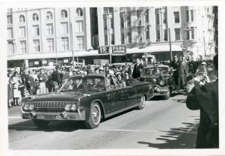 Black and white photograph of the presidential limousine in Dallas