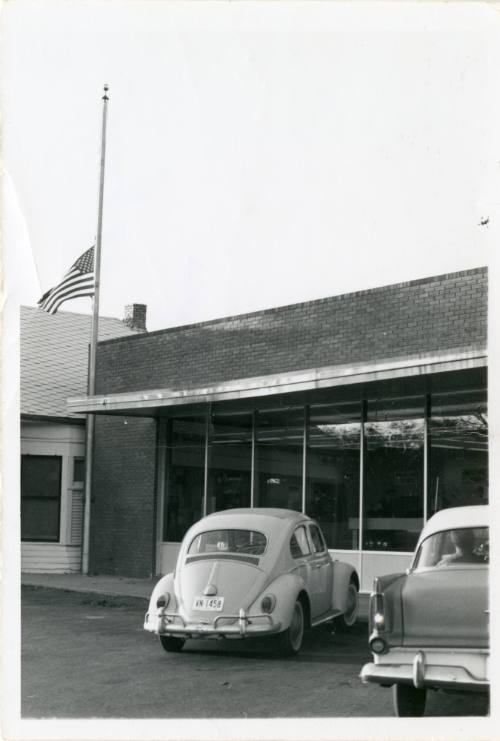Black and white photograph of flag at half-staff hours after the assassination