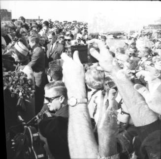 Image of the Kennedys greeting the crowd at Love Field