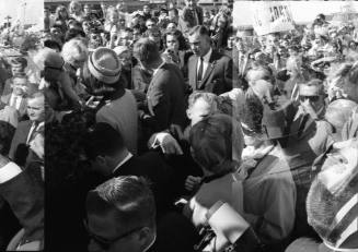 Image of the Kennedys greeting the crowd at Love Field