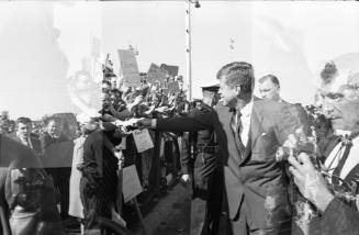 Image of President Kennedy greeting the crowd at Love Field
